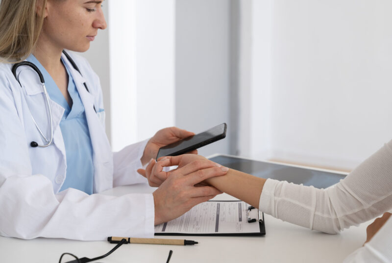 side view doctor holding smartphone