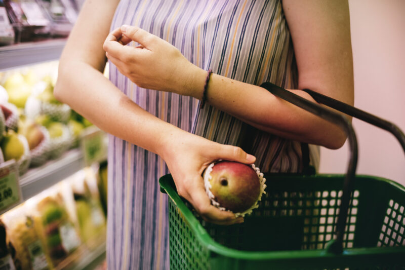 woman selecting an apple at the supermarket